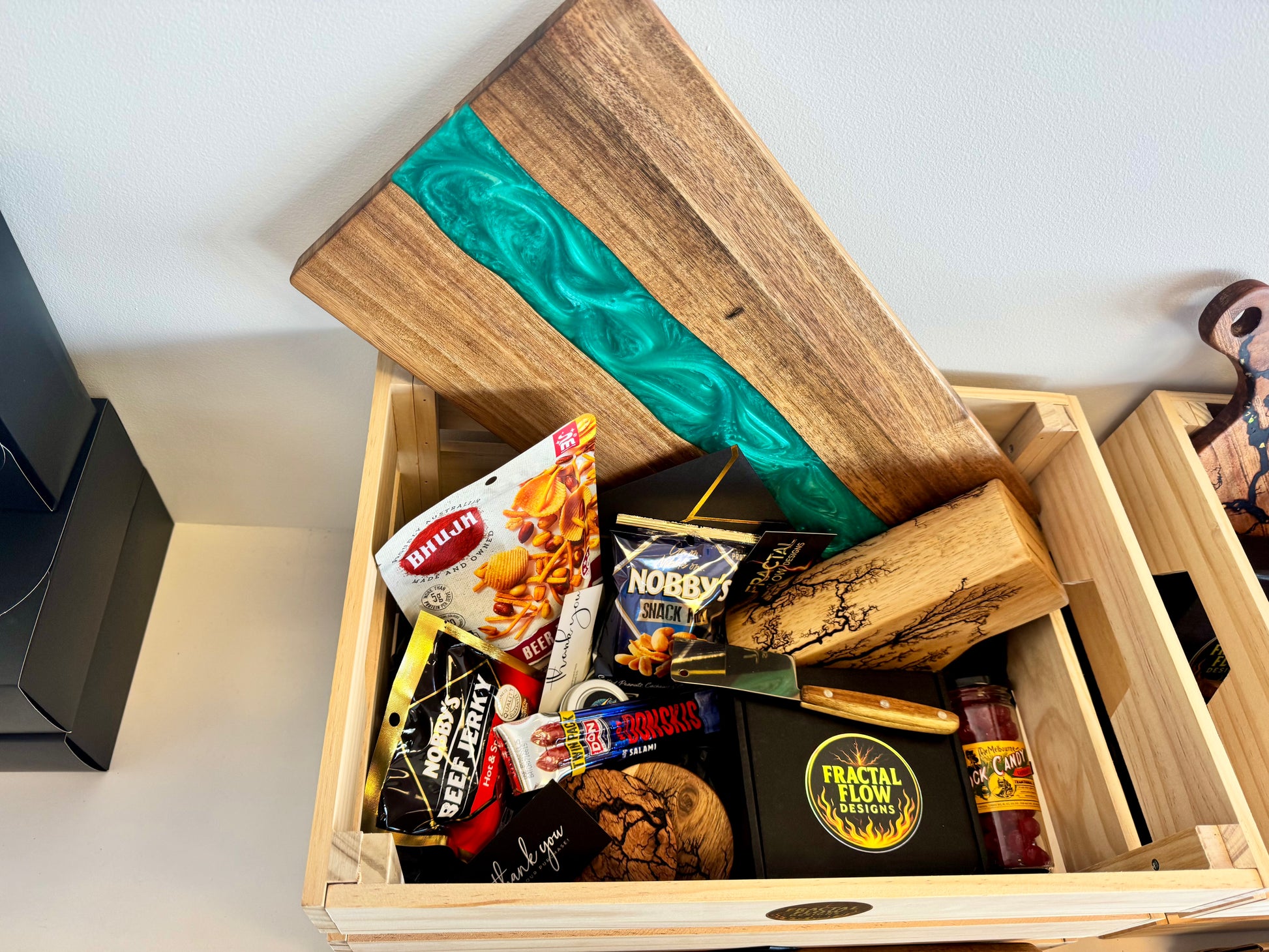 Australian resin cheese board gift hamper with paddle, snacks, cheese knife, care kit, and crate – handcrafted in Bairnsdale by Fractal Flow Designs
