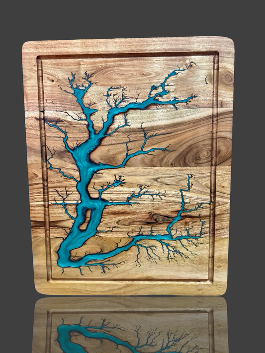 Handcrafted in Bairnsdale, Victoria, this premium Australian-made chopping board features stunning electric fractal burning and deep resin accents on solid acacia timber. Designed for durability and visual impact, it’s ideal for kitchen prep, grazing platters, charcuterie spreads, or gift occasions. Every board is one-of-a-kind, showcasing natural grain patterns fused with lightning-burned artwork and ocean-like resin flow. Perfect as a wedding gift, birthday present, Ships Australia wide